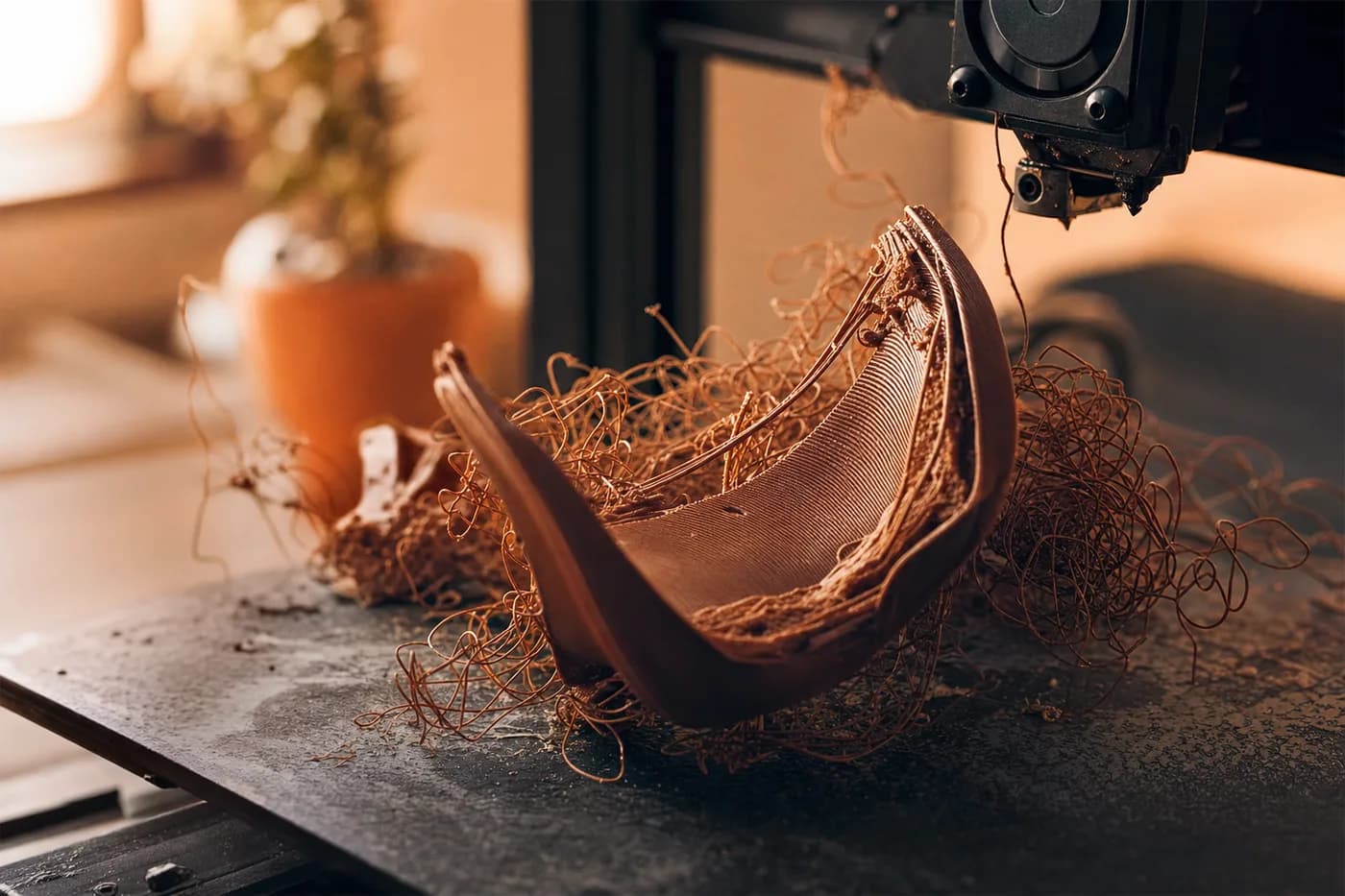 A failed 3D print, warped and detached from the bed